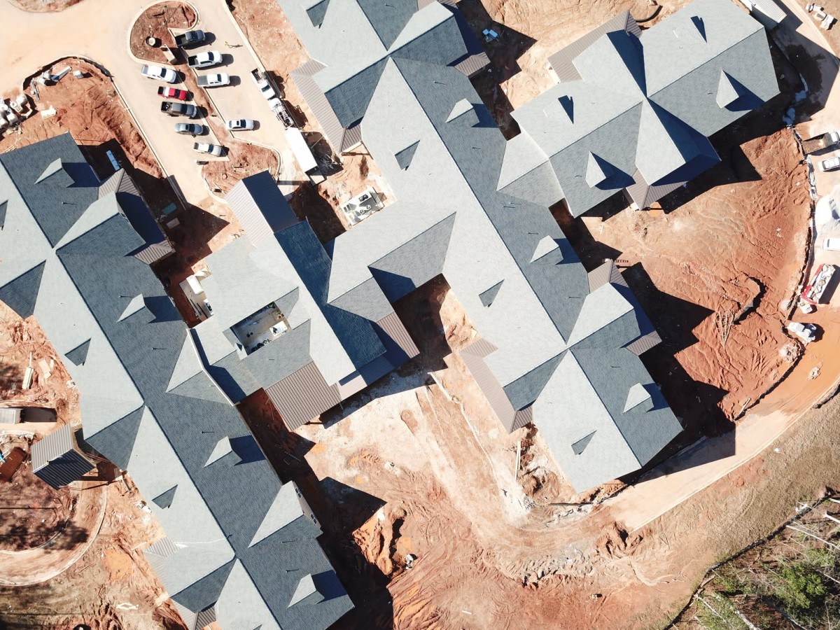 Aerial view of a housing development under construction, showcasing the rooftops and layout.
