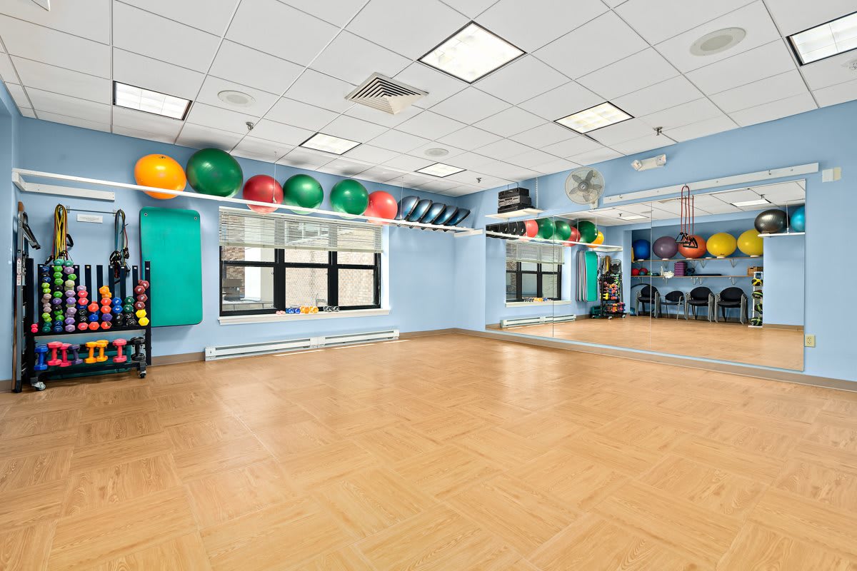A spacious exercise room equipped with fitness balls and various workout equipment.