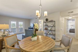 A cozy dining area featuring a round wooden table and modern decor.