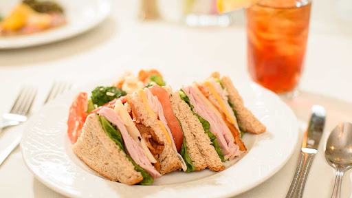 A deliciously stacked sandwich featuring turkey, fresh vegetables, and whole grain bread.