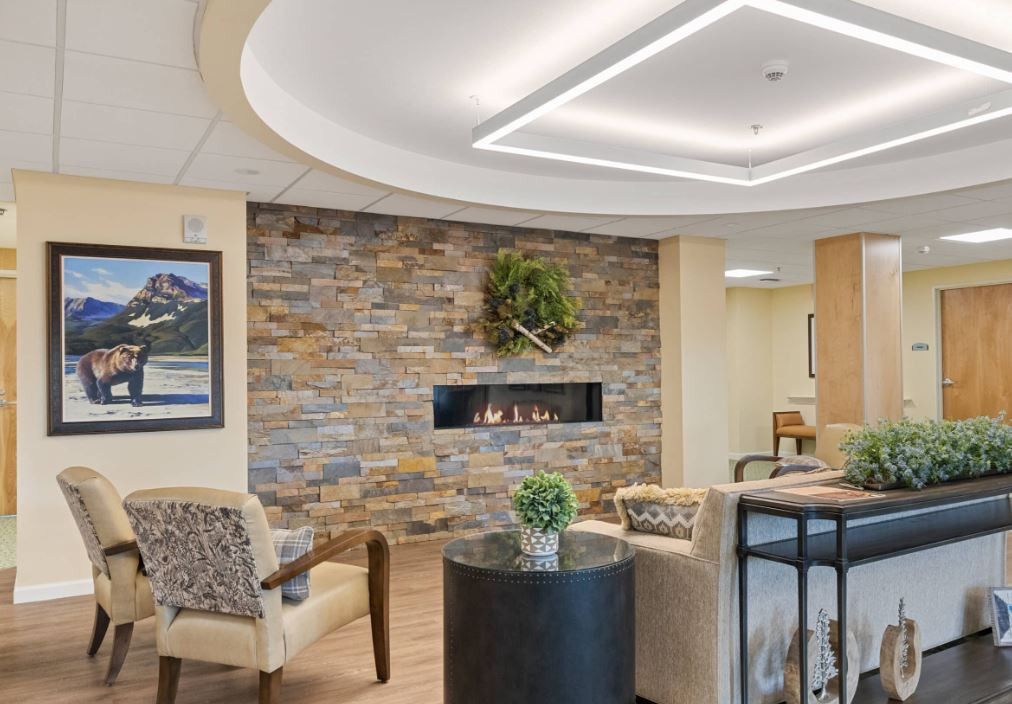 A modern lobby with a stone wall fireplace and comfortable seating.
