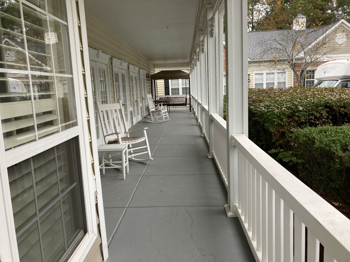 A cozy porch with rocking chairs lining the walkway, perfect for relaxation.