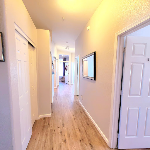A well-lit hallway showcasing doors and a clean, modern aesthetic.