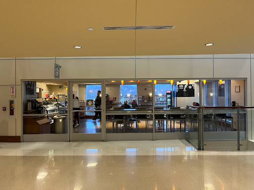 A view of the dining area inside an airport, showcasing various food options.