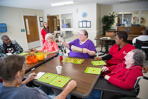 Residents and staff enjoying a lively game of bingo in a community center.
