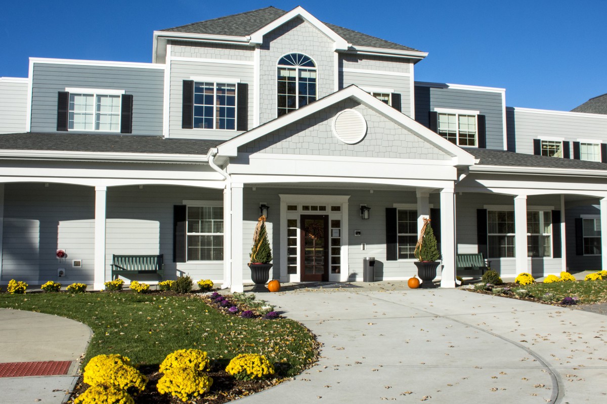 A two-story house with a well-maintained front entrance and landscaping.