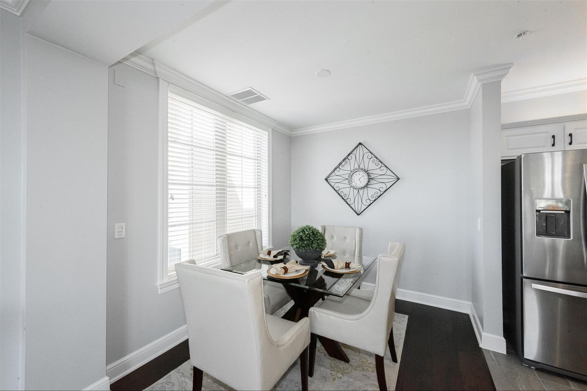 A modern dining room with a neutral color palette and stylish decor.