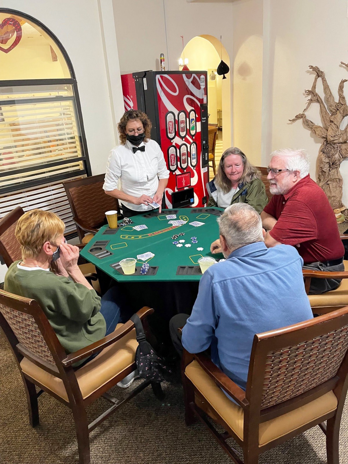 A group of seniors enjoying a game of poker indoors.