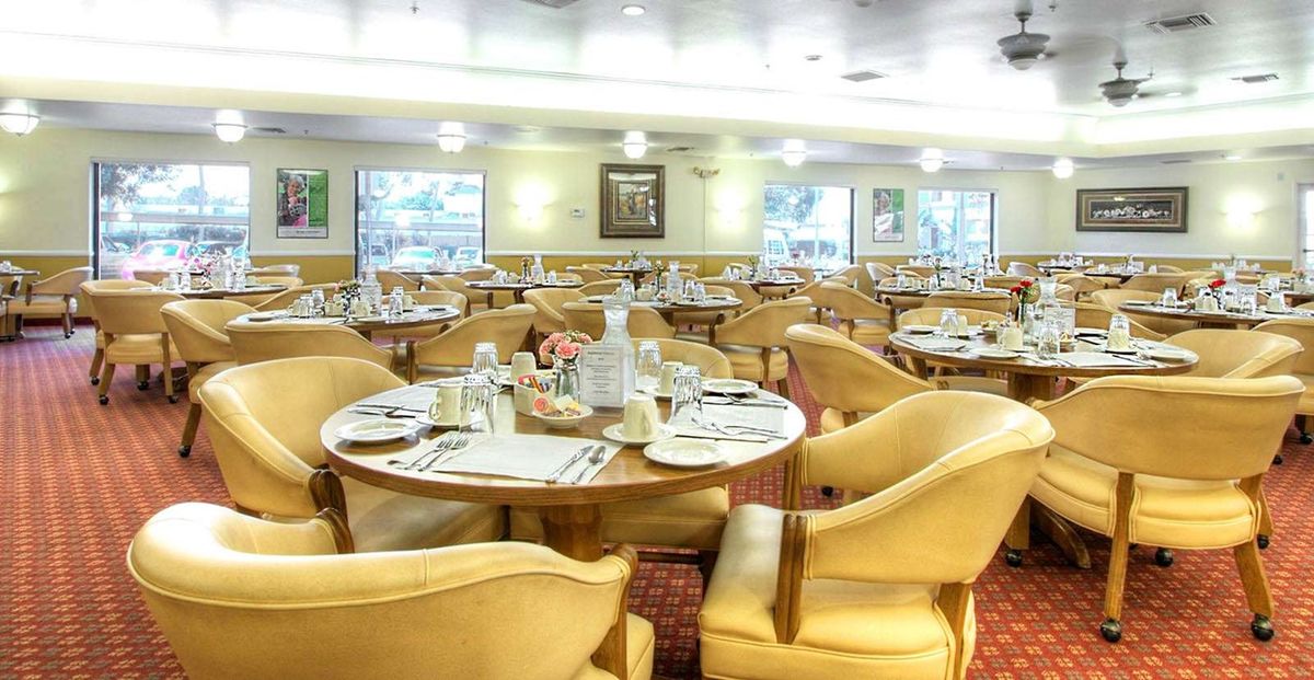 An elegant dining room with neatly arranged tables and comfortable chairs.