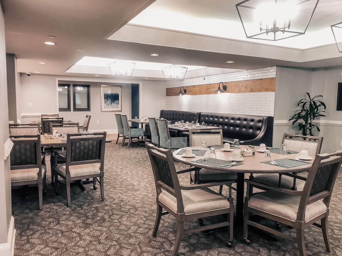 An elegantly designed restaurant interior with set tables and comfortable seating.