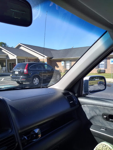 A parked SUV in a parking lot next to a building.