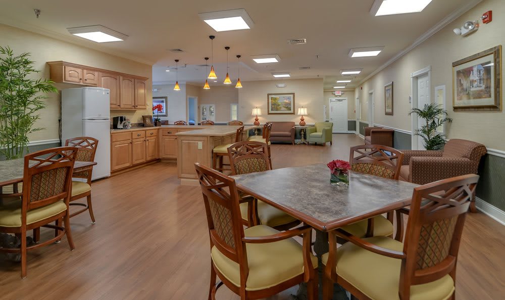 A spacious and well-lit open-concept dining and kitchen area with comfortable seating.
