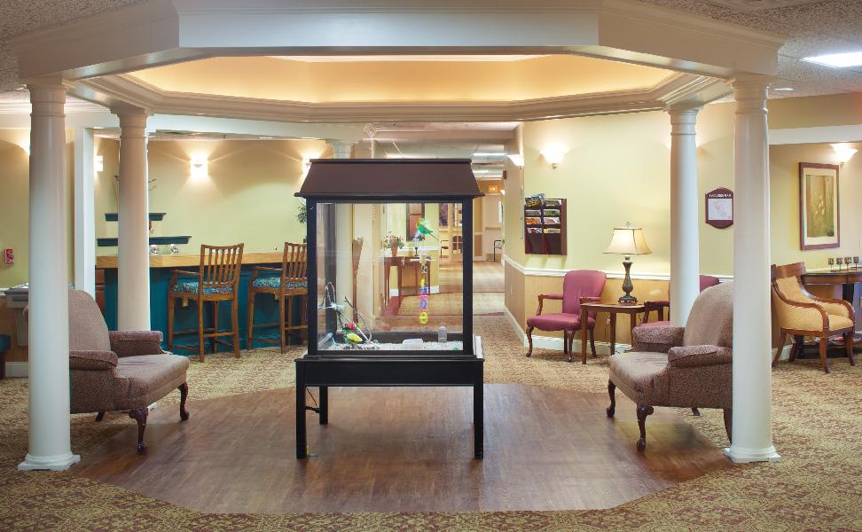 A cozy lobby area featuring comfortable seating and a central display case.