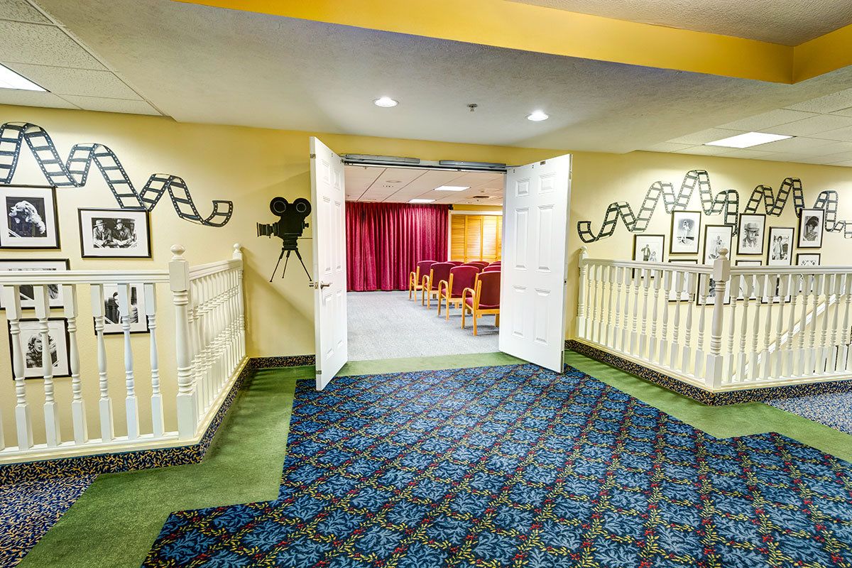 A small indoor cinema with film-themed decorations and seating.