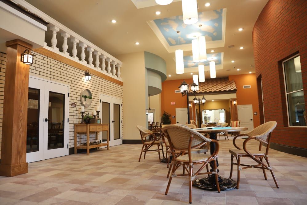 A spacious and elegantly decorated restaurant interior with ample seating and modern lighting fixtures.