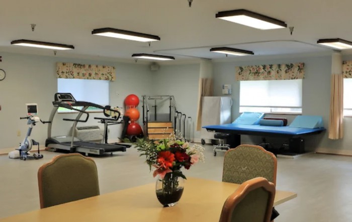 A physical therapy room equipped with exercise machines and rehabilitation tools.