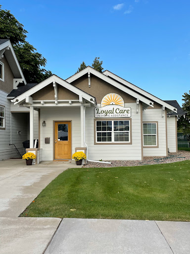 A charming single-story house with a welcoming entrance and well-maintained landscaping.