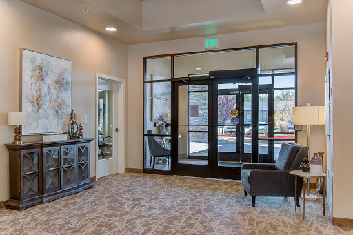 A modern lobby featuring a cozy seating area and large glass doors that provide ample natural light.