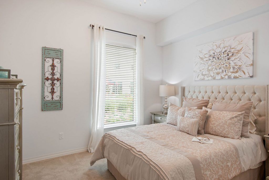 A cozy bedroom with modern decor and natural lighting.