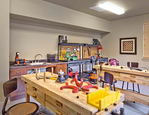 A well-equipped workshop with various tools and work tables ready for crafting and woodworking activities.