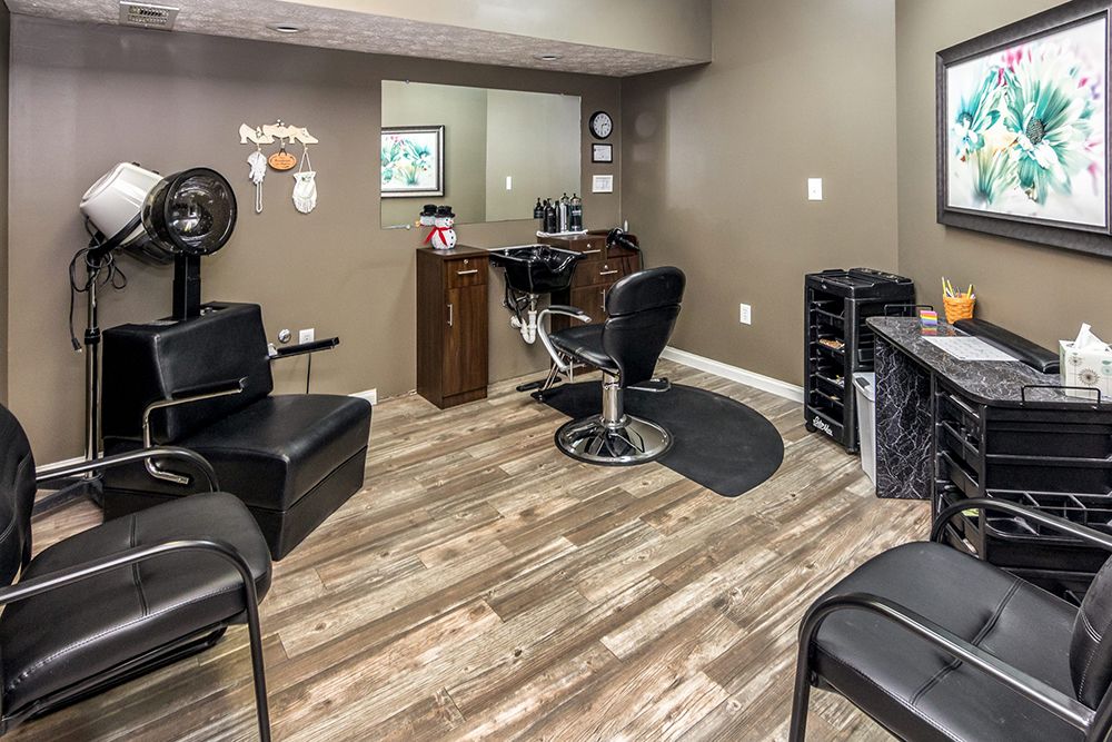 A modern hair salon with stylish chairs and a wooden floor.