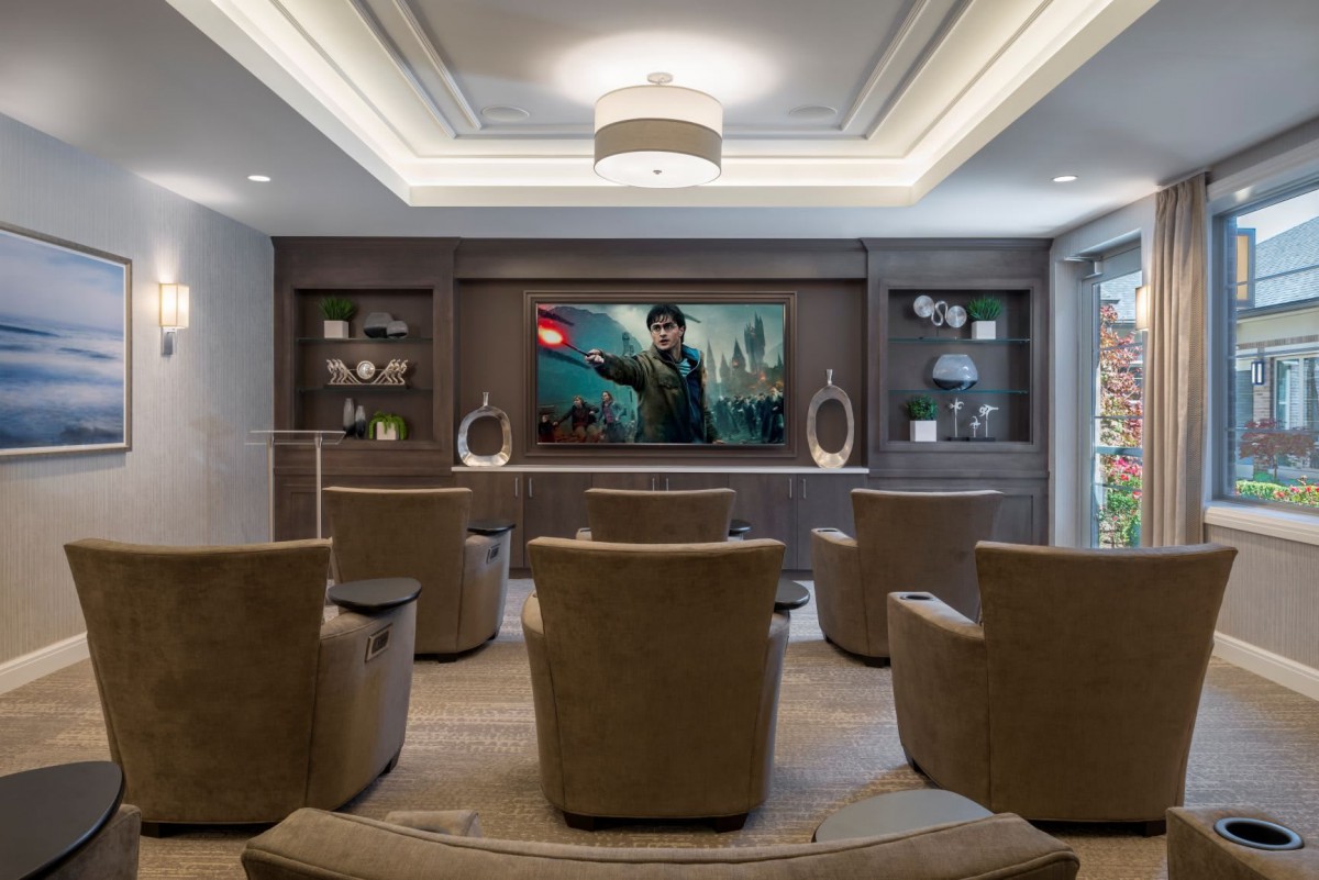 A modern home theater with plush seating and a large screen for an ultimate entertainment experience.