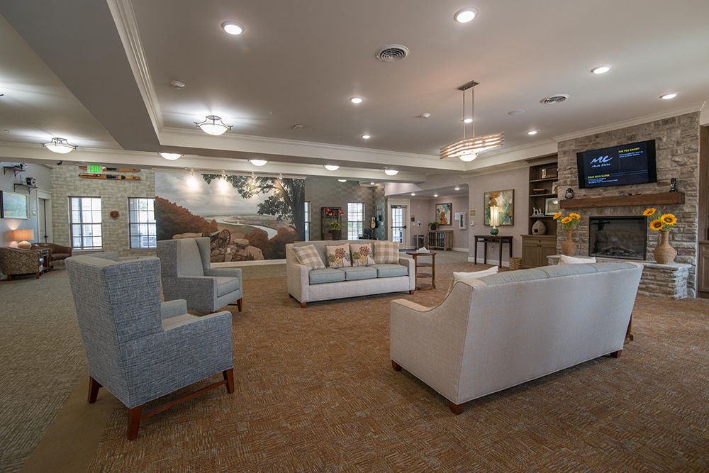 A spacious and elegantly furnished living room with sofas, armchairs, and tasteful decor.