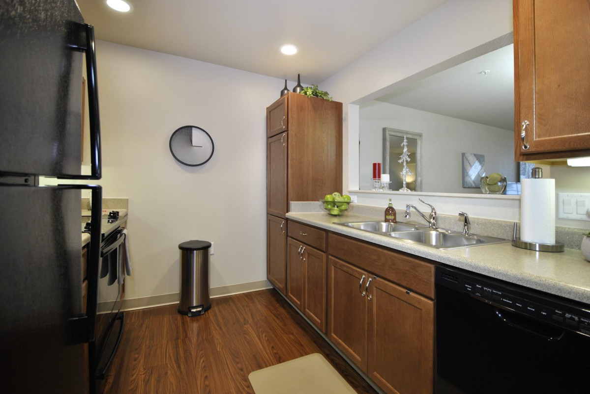 Modern kitchen with wooden cabinets and a sleek countertop.