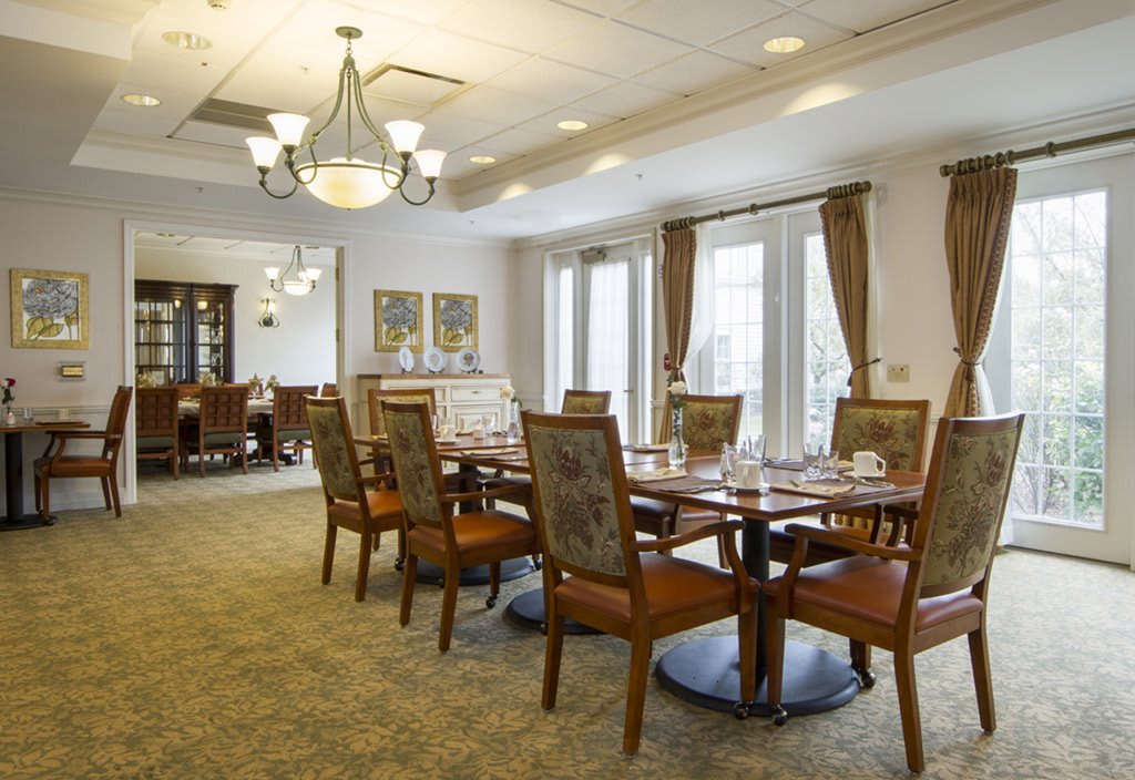A well-appointed dining room with elegant furniture and a chandelier.