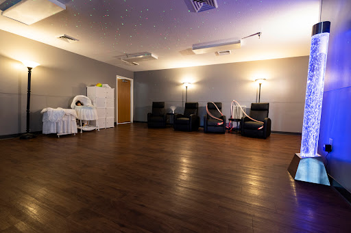 A modern waiting room featuring comfortable recliners and soft lighting, designed for relaxation.