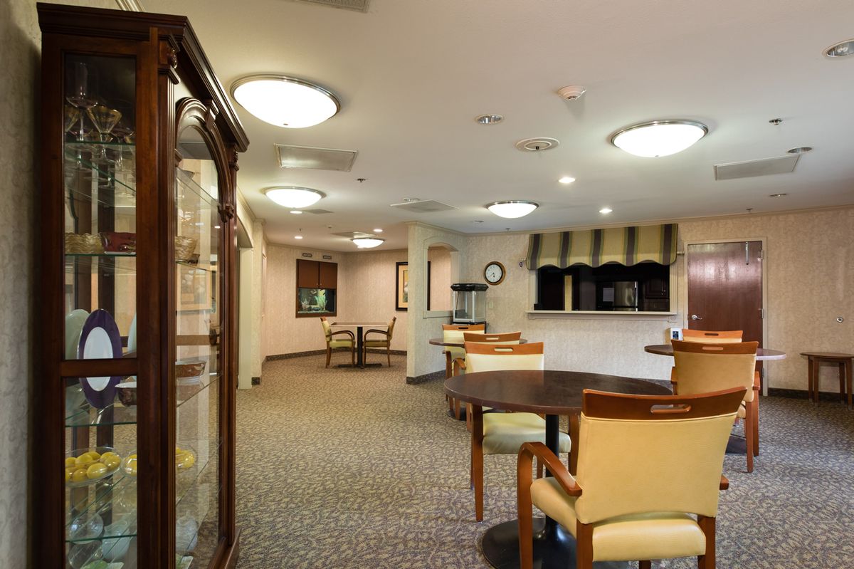 A well-lit lobby area with seating and classic decor.