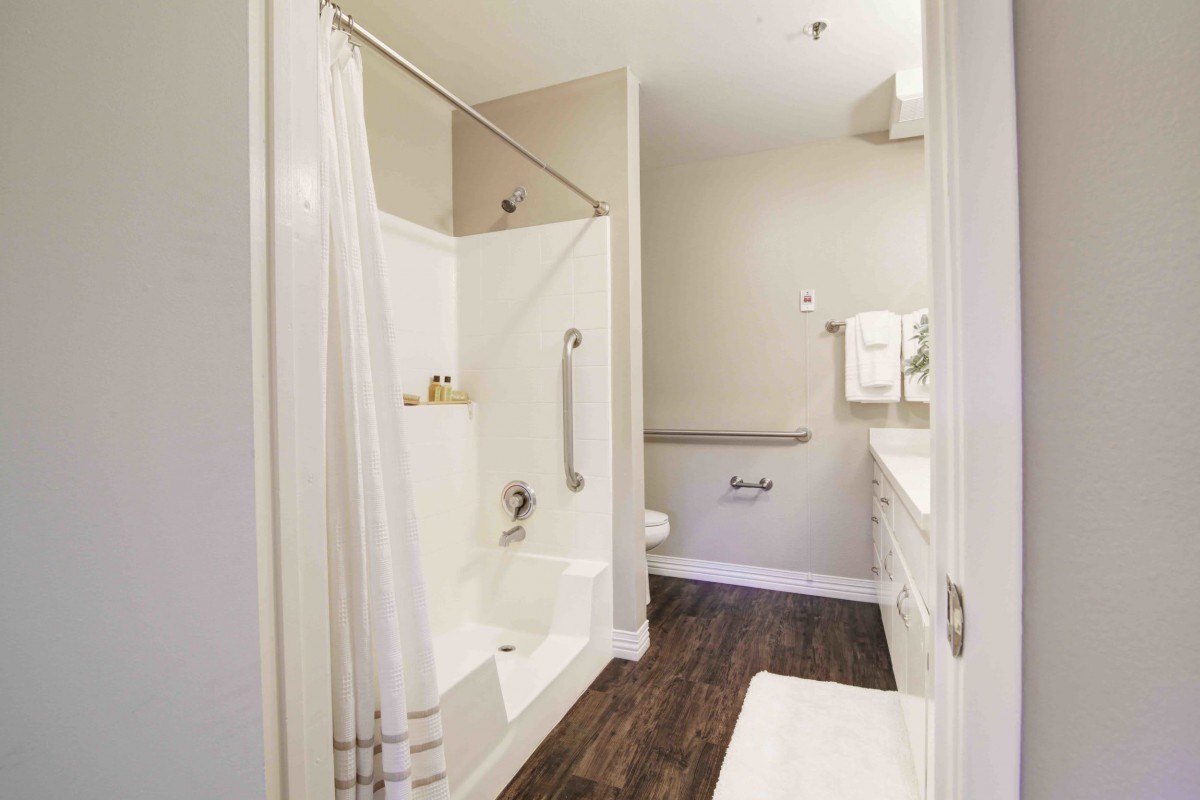 A modern and clean bathroom featuring a shower, sink, and toilet.