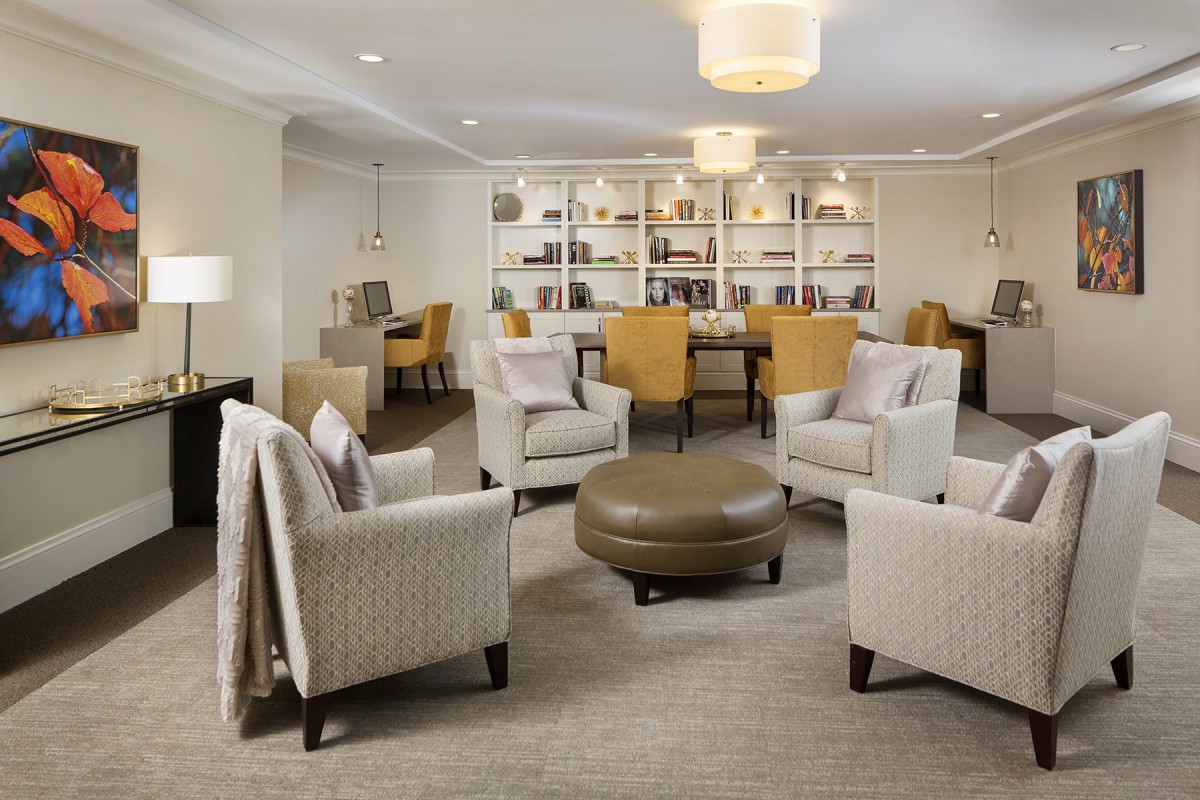 A modern living room with comfortable seating and a bookshelf.