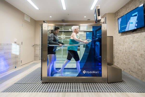 A person using an underwater treadmill for rehabilitation and exercise.