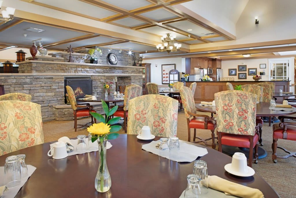 A cozy dining room with elegant decor and a welcoming fireplace.