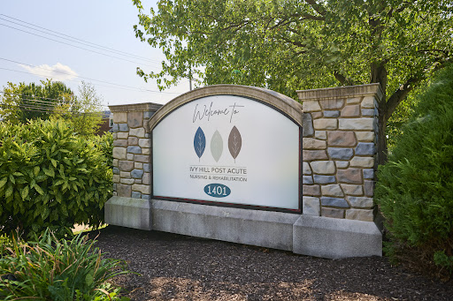A well-designed stone sign displaying colors and branding elements, set in a lush outdoor environment.