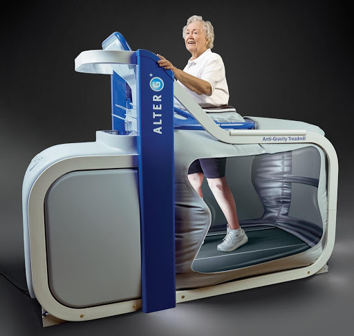 An elderly person enjoying a workout on a specialized treadmill designed for rehabilitation and fitness.