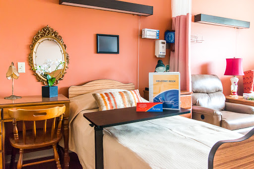 A cozy patient room designed to provide comfort with warm colors and essential amenities.
