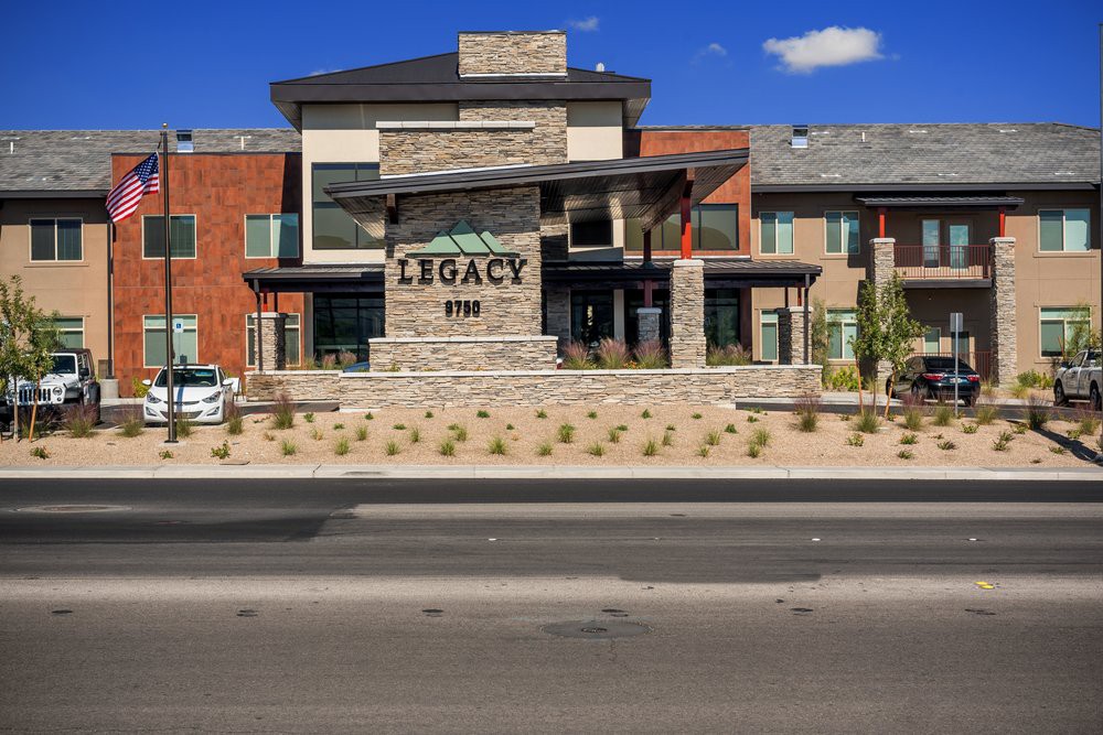 A modern commercial building with the name 'Legacy' displayed prominently on a stone facade.