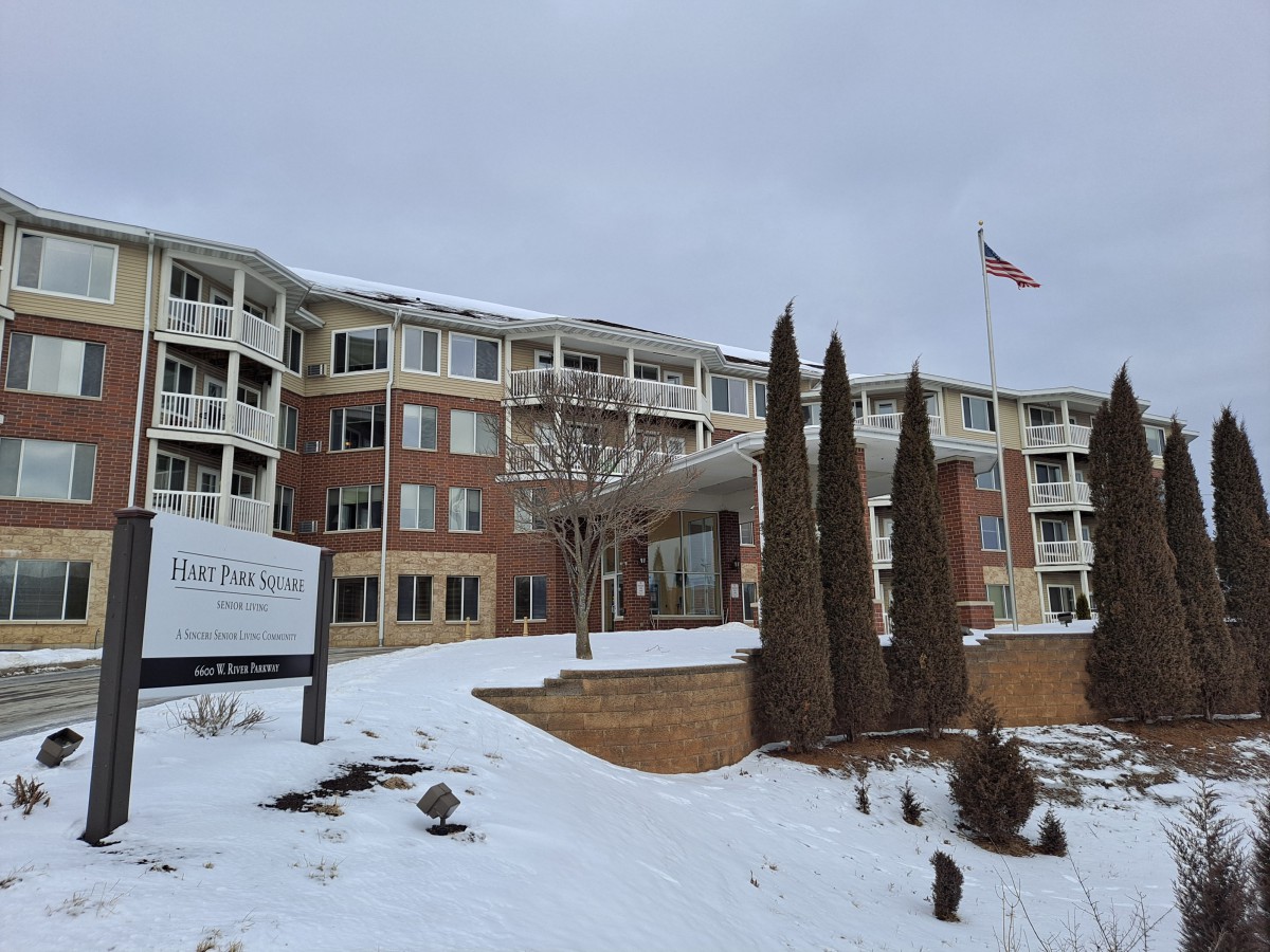 A snow-covered facility with an American flag flying outside.