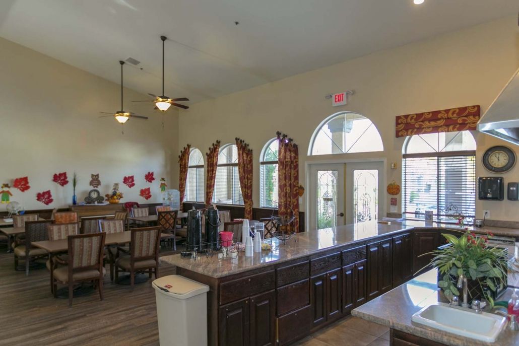 Spacious kitchen and dining area with large windows and seating.