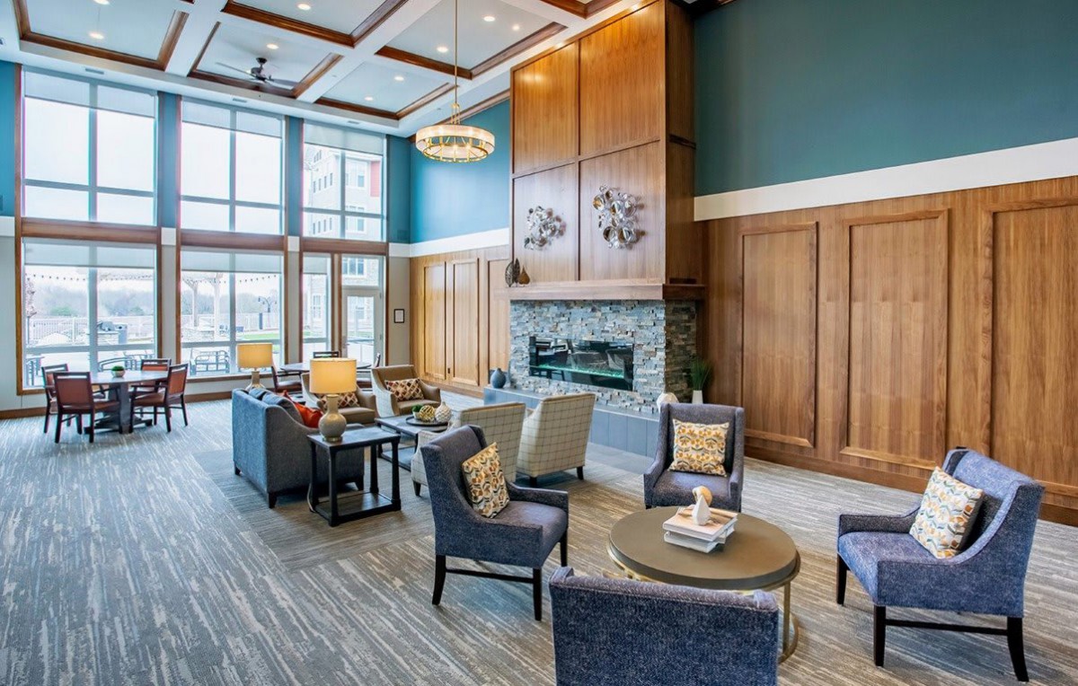 A modern and cozy lobby with comfortable seating and a fireplace.