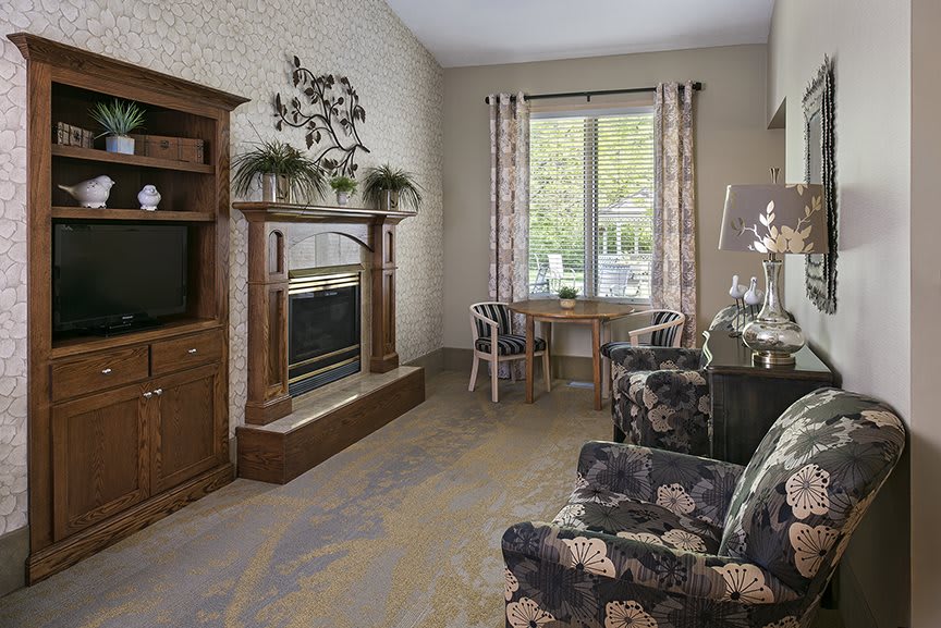 Cozy living room with a fireplace, television, and comfortable seating.