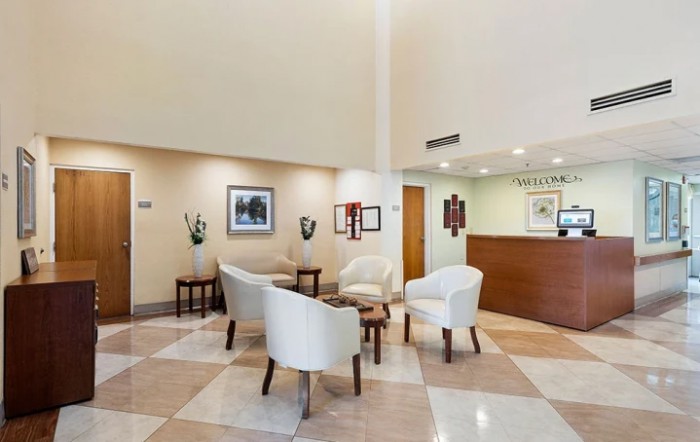 A modern hotel lobby with a seating area and reception desk.
