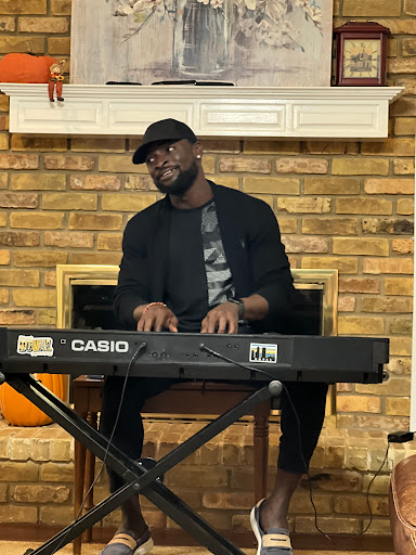 A talented musician performing on a Casio keyboard in a cozy setting.
