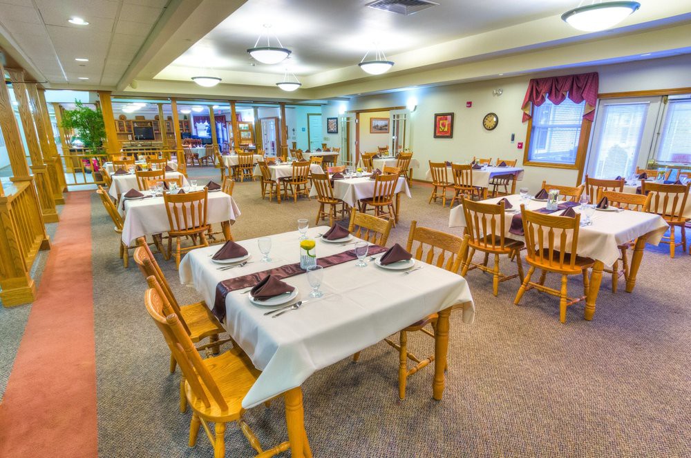 A cozy dining room with neatly arranged tables and chairs, ready for guests.