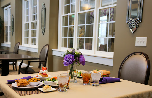A beautifully arranged dining table with various dishes and a floral centerpiece.