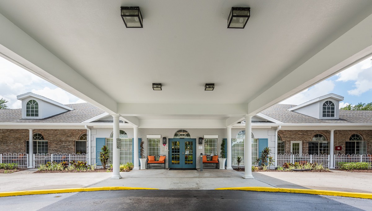 A building entrance with a covered awning and columns.
