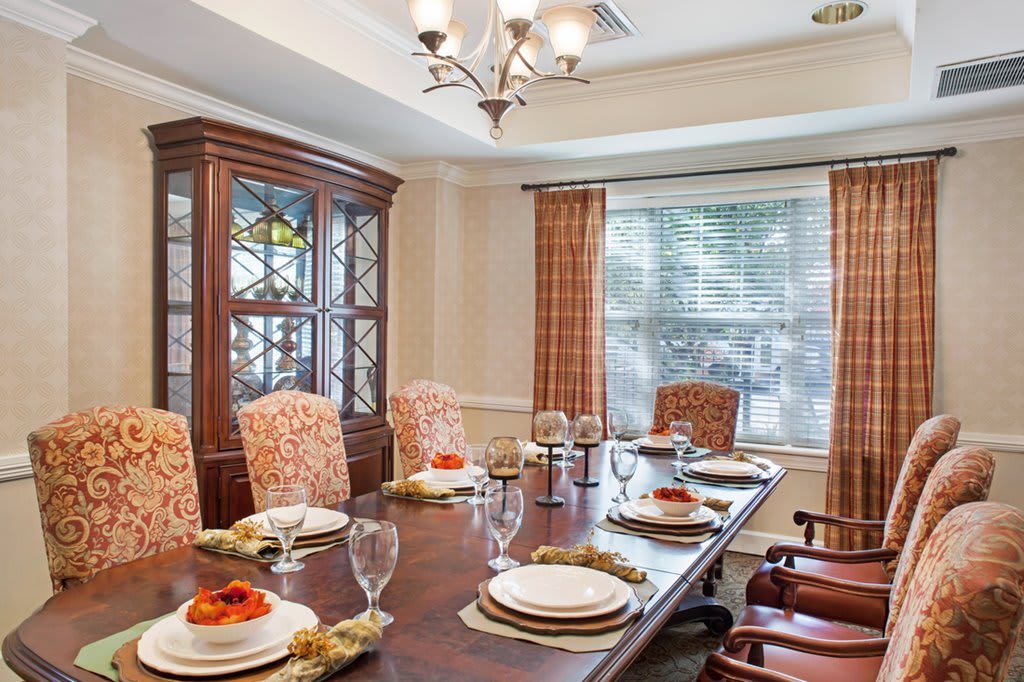 A well-appointed dining room with an elegant table setting and chandelier.