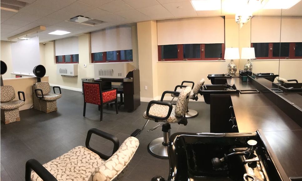 A modern salon interior with styling chairs and mirrors.